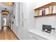 A bright white kitchen is designed with modern cabinetry, stone countertops, and gold accents at 12009 Sw 61St Place Road, Ocala, FL 34481