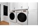 The laundry room includes modern white cabinets with black hardware, and Samsung front-load washer and dryer at 12009 Sw 61St Place Road, Ocala, FL 34481