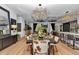 Open-concept living room boasts an elegant chandelier, dining table, and a comfortable seating area with fireplace at 12009 Sw 61St Place Road, Ocala, FL 34481