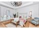 Beautiful main bedroom with a ceiling fan, wooden floors, and french doors leading to the outside at 12009 Sw 61St Place Road, Ocala, FL 34481