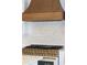 Close-up of a gold-trimmed gas stove with a decorative tile backsplash and a wooden range hood at 12009 Sw 61St Place Road, Ocala, FL 34481