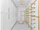 Spacious walk-in closet with custom storage, bright lighting, and a comfortable ottoman at 12009 Sw 61St Place Road, Ocala, FL 34481