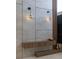 Stylish wall decor with floating console, decorative vases, and modern sconce lighting at 15614 Espalier Way, Winter Garden, FL 34787