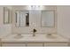 Double vanity bathroom with large mirrors and updated light fixture at 8009 Applehill Ct, Orlando, FL 32810