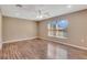 Bright bedroom featuring laminate wood flooring and a large window at 8009 Applehill Ct, Orlando, FL 32810