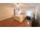 Spacious bedroom featuring wood floors and a ceiling fan at 8009 Applehill Ct, Orlando, FL 32810