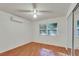 Well-lit bedroom with wood floors and window blinds at 8009 Applehill Ct, Orlando, FL 32810