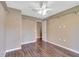 Simple bedroom with laminate wood flooring and an additional door at 8009 Applehill Ct, Orlando, FL 32810