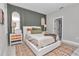 Inviting bedroom showcases paneled wall, cozy bedding, bedside tables, and decor at 9665 Sw 125 Ter, Dunnellon, FL 34432