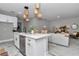 Open-concept kitchen with a quartz island, seamlessly connected to the living area, creating an ideal space for modern living at 9665 Sw 125 Ter, Dunnellon, FL 34432