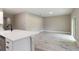 Open-concept living room with gray flooring that connects to the kitchen area and natural light at 9665 Sw 125 Ter, Dunnellon, FL 34432