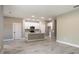 Spacious living room with tile flooring, white trim, and a well-lit kitchen area in the background at 9665 Sw 125 Ter, Dunnellon, FL 34432