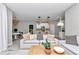 Open-concept living room with seamless flow to the kitchen, featuring stylish pendant lights and comfortable seating at 9665 Sw 125 Ter, Dunnellon, FL 34432
