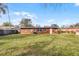 Large backyard of the house with spacious grass area at 2313 Savoy Dr, Orlando, FL 32808