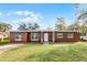 Front view of charming ranch house with green lawn at 2313 Savoy Dr, Orlando, FL 32808