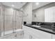 Clean bathroom with glass-door shower, single sink vanity with granite countertop and tile flooring at 4457 Le Reve Ct, Kissimmee, FL 34746