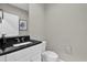 Cozy bathroom with black granite countertop, vessel sink, and soft, neutral wall color at 4457 Le Reve Ct, Kissimmee, FL 34746