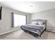 Comfortable bedroom with large window and a queen size bed with gray bedding at 4457 Le Reve Ct, Kissimmee, FL 34746