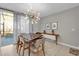 Bright dining area with modern lighting, tile floor, and sliding door to outdoor pool at 4457 Le Reve Ct, Kissimmee, FL 34746