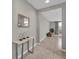 Bright foyer featuring neutral walls, a modern console table, and tile floors leading into the home's living spaces at 4457 Le Reve Ct, Kissimmee, FL 34746