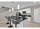 Contemporary kitchen with a black countertop island, stainless steel appliances, and ample cabinet space for storage at 4457 Le Reve Ct, Kissimmee, FL 34746