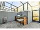 Outdoor kitchen under enclosed patio offers a built-in grill, counter space, and a functional setup at 4457 Le Reve Ct, Kissimmee, FL 34746