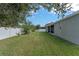 Well-manicured backyard with green grass and a white vinyl fence at 658 Lake Cove Pointe Cir, Winter Garden, FL 34787