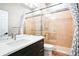 Bathroom featuring a vanity with dark cabinetry, a shower, and tiled floors at 7700 Carriage Homes Dr # 4, Orlando, FL 32819