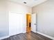 Bedroom featuring laminate flooring, closet space, and access to an ensuite bathroom at 7700 Carriage Homes Dr # 4, Orlando, FL 32819
