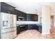 Beautiful kitchen with stainless steel appliances, dark cabinets, and tiled backsplash at 7700 Carriage Homes Dr # 4, Orlando, FL 32819