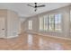 Bright living room with neutral walls, terra cotta tile floors, plantation shutters, and a modern ceiling fan at 7700 Carriage Homes Dr # 4, Orlando, FL 32819