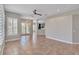 Large living room featuring tile flooring, neutral walls, plantation shutters, and an open concept floor plan at 7700 Carriage Homes Dr # 4, Orlando, FL 32819