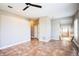 Neutral living room featuring tile flooring, neutral walls, plantation shutters, and open concept staircase at 7700 Carriage Homes Dr # 4, Orlando, FL 32819