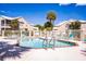 A community pool features lounge chairs and is enclosed by a white metal fence at 7700 Carriage Homes Dr # 4, Orlando, FL 32819