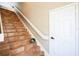 Interior view of a staircase with terra cotta tile risers and treads, a white banister and white door at 7700 Carriage Homes Dr # 4, Orlando, FL 32819