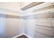 A walk-in closet features wire shelving on multiple walls and a wood floor at 7700 Carriage Homes Dr # 4, Orlando, FL 32819