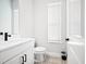 Stylish powder room featuring patterned tile floor, sleek vanity, and natural light from window at 777 Halifax Ave, Winter Park, FL 32792