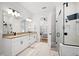 Bright bathroom features a double vanity, glass shower, and a view into the main bedroom at 777 Halifax Ave, Winter Park, FL 32792