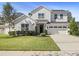 Charming two-story home with white siding, a well-manicured lawn, and an attached two-car garage at 777 Halifax Ave, Winter Park, FL 32792