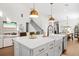 Spacious kitchen island featuring a white countertop, farmhouse sink, and stylish pendant lighting above at 777 Halifax Ave, Winter Park, FL 32792