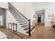 A staircase with dark wood steps and wrought iron railings leads to the upper level at 777 Halifax Ave, Winter Park, FL 32792