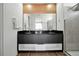 Bathroom featuring double sinks with black countertops at 836 Desert Mountain Ct, Reunion, FL 34747