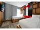 Playful bedroom featuring twin beds, striped accent wall and tuxedo themed design with bright red bowtie at 836 Desert Mountain Ct, Reunion, FL 34747