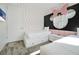 Adorable bedroom with twin beds, polka dot accent wall and playful Minnie Mouse design headboard at 836 Desert Mountain Ct, Reunion, FL 34747