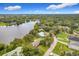 An aerial view of the home on the lake, surrounded by mature trees at 119 Lake Dr, Oviedo, FL 32765