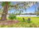 Scenic backyard with mature trees, chairs, and serene lake views at 119 Lake Dr, Oviedo, FL 32765