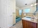 A bathroom with swan décor on the bathtub doors and vintage blue tile at 119 Lake Dr, Oviedo, FL 32765