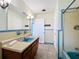 Tiled bathroom featuring a tub and a large vanity sink at 119 Lake Dr, Oviedo, FL 32765