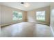 Well-lit bedroom with two windows and neutral colored walls at 119 Lake Dr, Oviedo, FL 32765