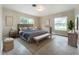 Bright bedroom with hardwood floors, modern furnishings, and an abundance of natural light at 119 Lake Dr, Oviedo, FL 32765